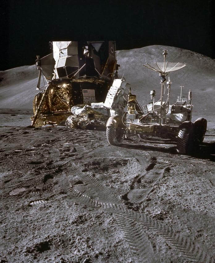 Astronaut footprints and tracks from the LRV are visible on the dusty surface of the moon, pictured here during Apollo 15.