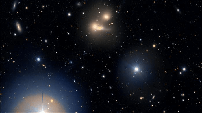 World’s largest visible light telescope spies a galaxy cluster warping spacetime_663bf4aeedcc8.png