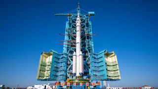 a white and blue rocket on a launch pad