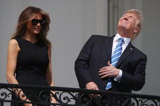 President Trump looks at the sun without protective gear during the solar eclipse of Aug. 21, 2017.