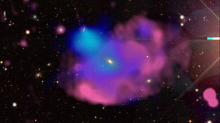 This multiwavelength image of the Cloverleaf ORC (odd radio circle) combines visible light observations from the DESI (Dark Energy Spectroscopic Instrument) Legacy Survey in white and yellow, X-rays from XMM-Newton in blue, and radio from ASKAP (the Australian Square Kilometer Array Pathfinder) in red.