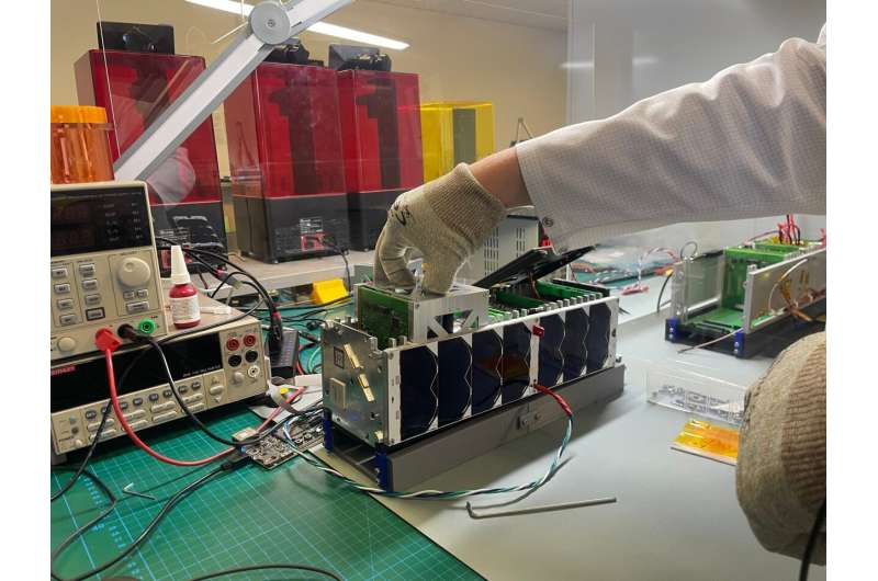 ADCS box (Attitude Determination and Control System) being installed in the qualification model of the InnoCube satellite. Credit: Tom Baumann / JMU Würzburg AI controls satellite