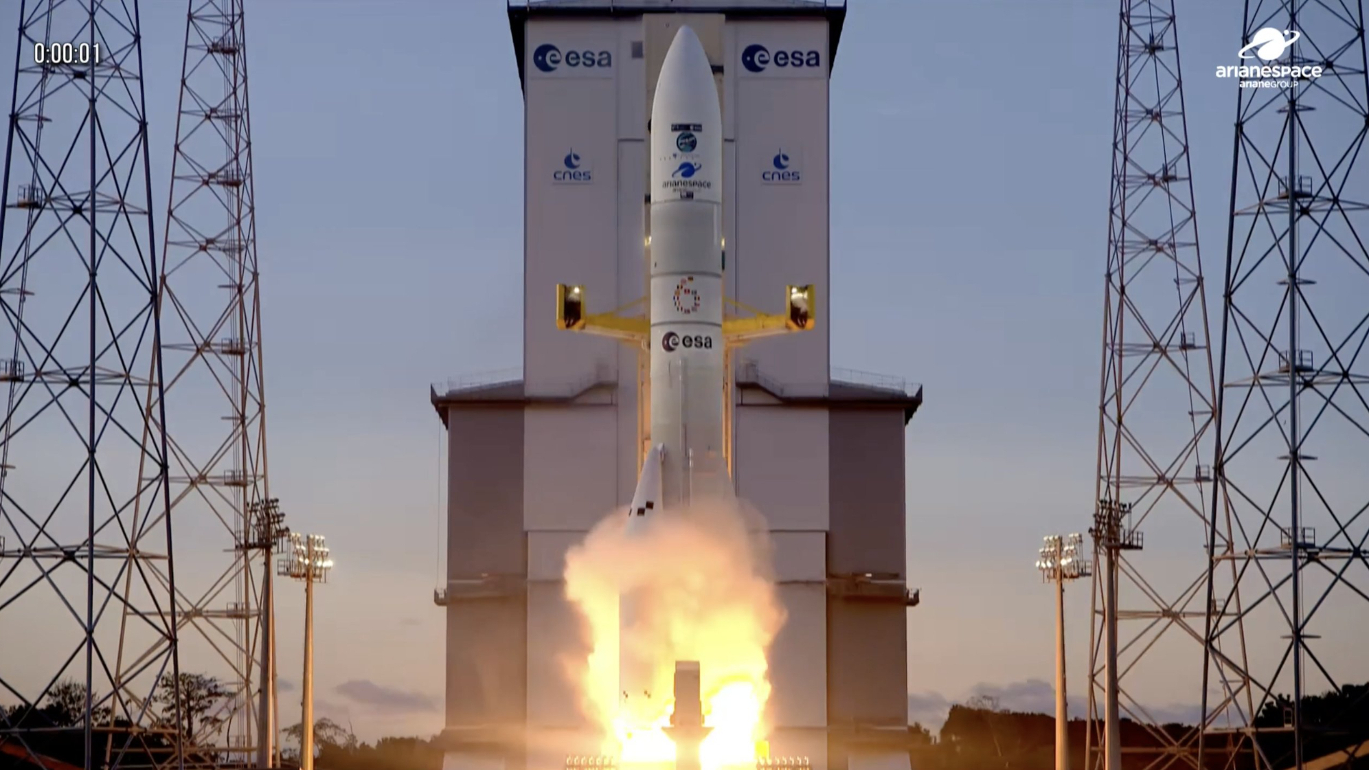 a large white rocket launches into a cloudy sky