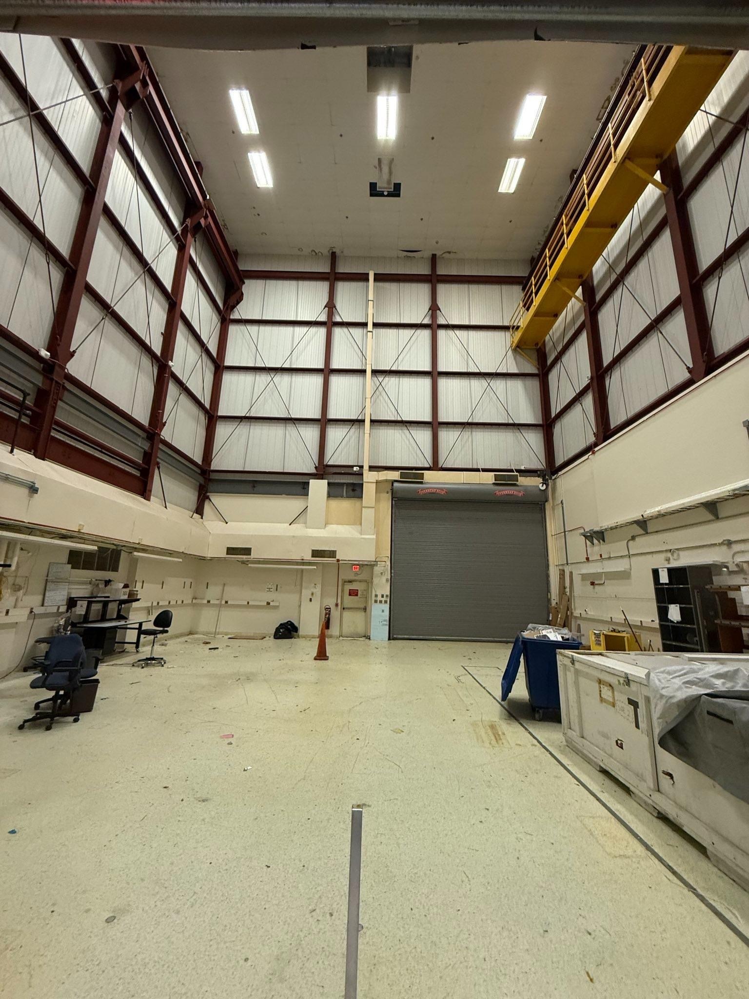 Various office spaces including desks, shelves and warehouses full of items stacked ready to be removed.