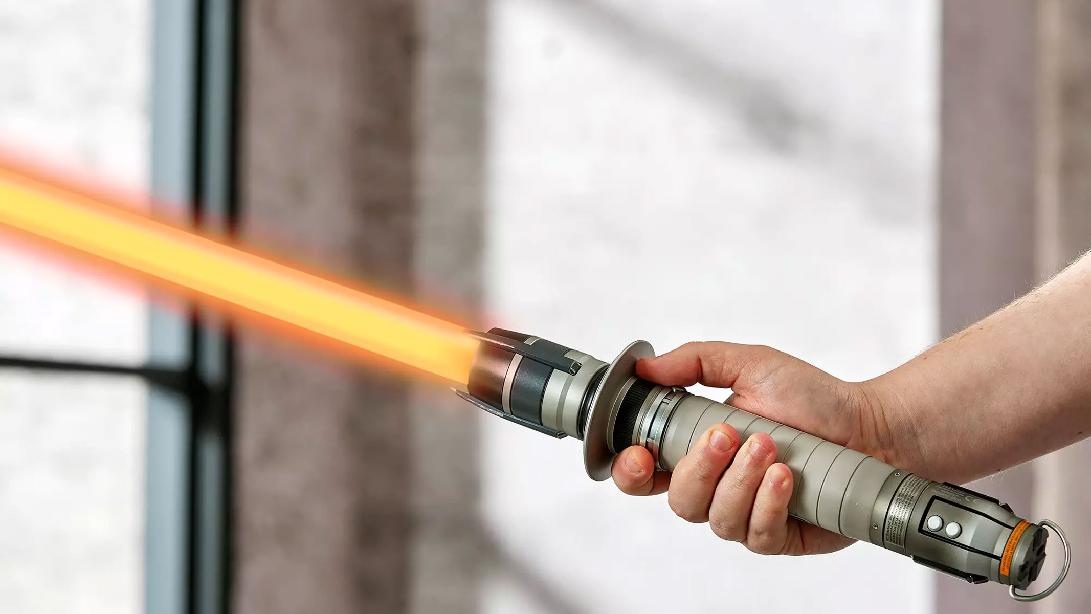 Two metal lightsabers with red glowing blades are displayed on a marbel surface.