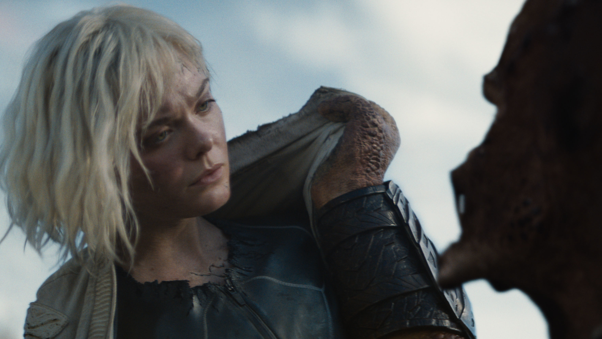 (L-R) Thia (Elle Fanning) and Dek (Dimitrius Schuster-Koloamatangi) in 20th Century Studios' PREDATOR: BADLANDS film. Photo courtesy of 20th Century Studios. © 2025 20th Century Studios. All Rights Reserved.