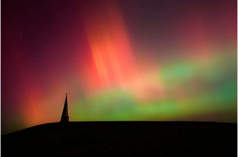 The northern lights fill the sky behind the Saint Joseph the Woodworker Shrine Tuesday, Nov. 11, 2025, near Valley Falls, Kan. Credit: AP Photo/Charlie Riedel Space forecasters say severe solar storms could hit Earth and trigger auroras