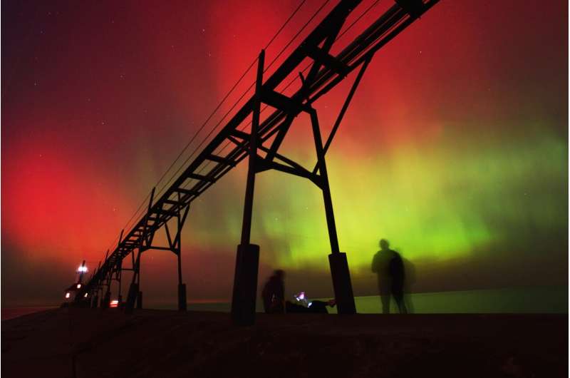 An aurora borealis, also known as the northern lights, lights up the night sky off Lake Michigan and the St. Joseph Lighthouse, Oct. 10, 2024, in St. Joseph, Mich. Credit: Don Campbell/The Herald-Palladium via AP, File Space forecasters say severe solar storms could hit Earth and trigger auroras
