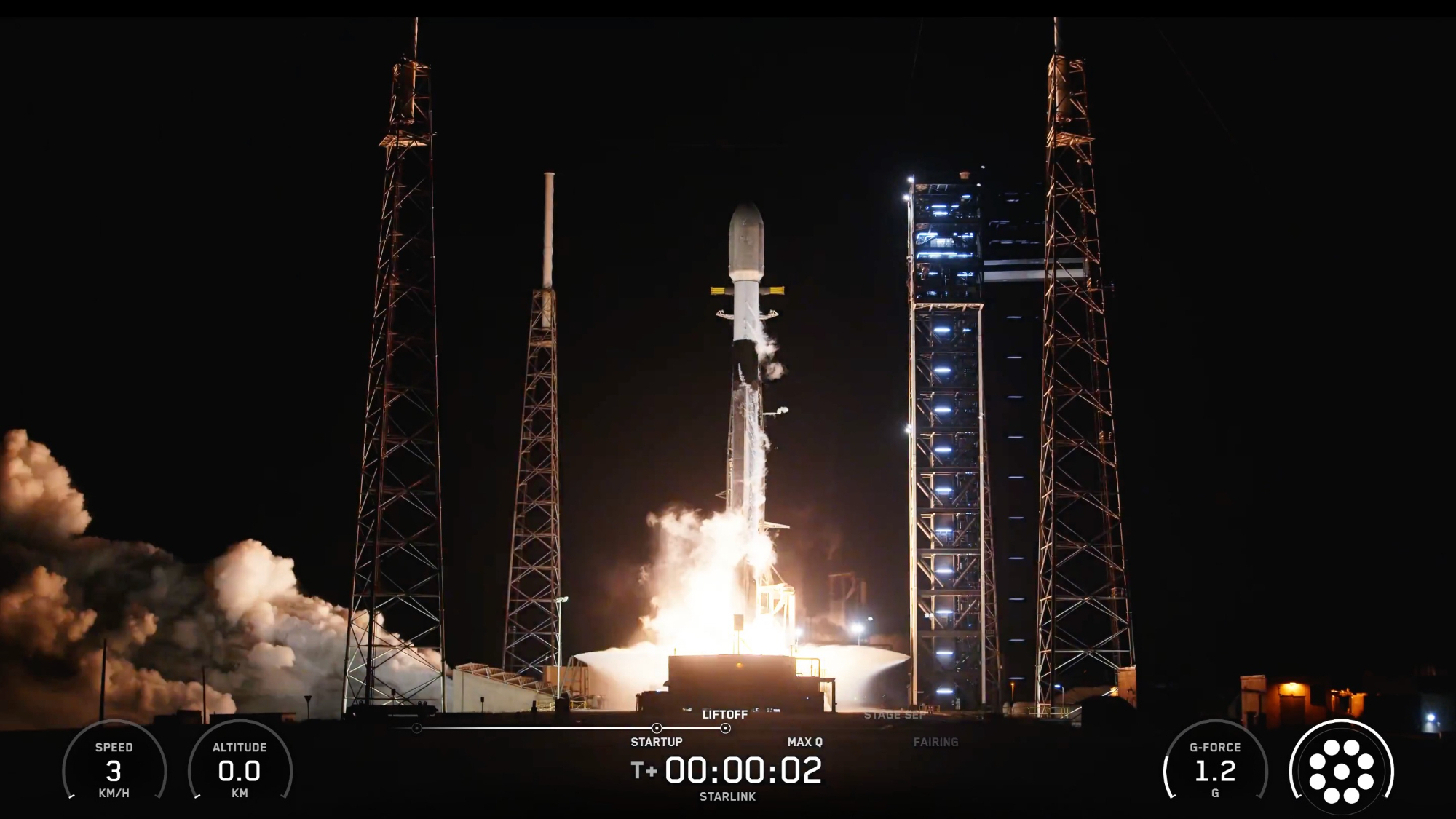 a black and white rocket launches into a dark night sky