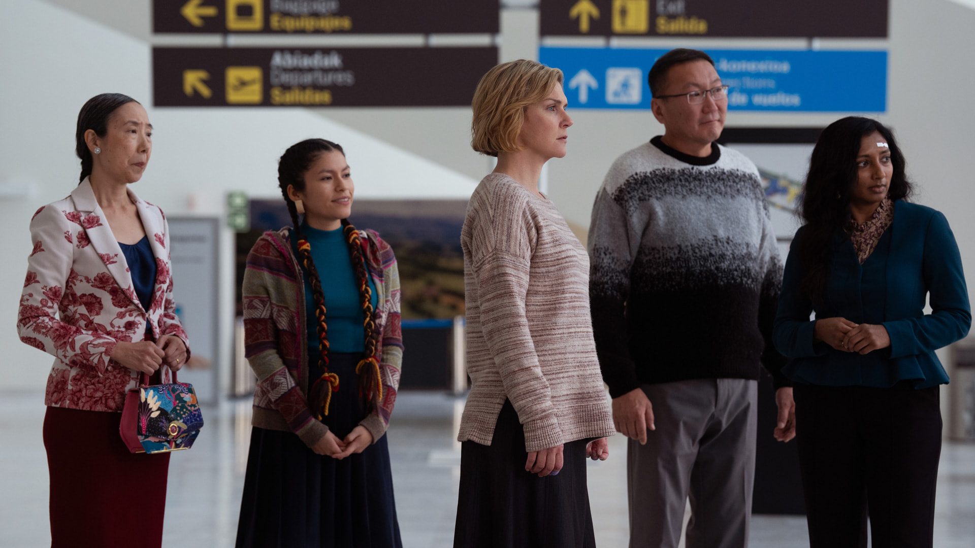 A group of five persons in an airport