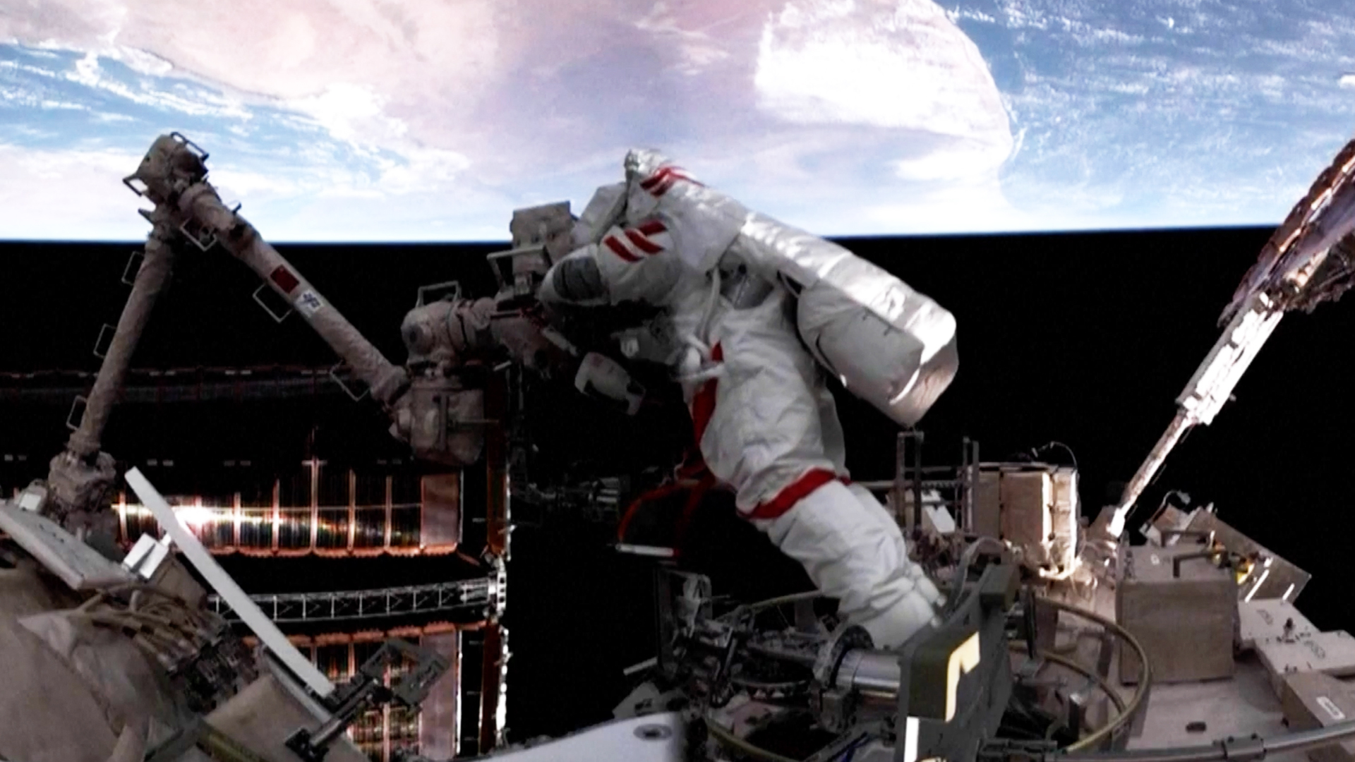 an astronaut in a white spacesuit works outside a space station with earth in the background