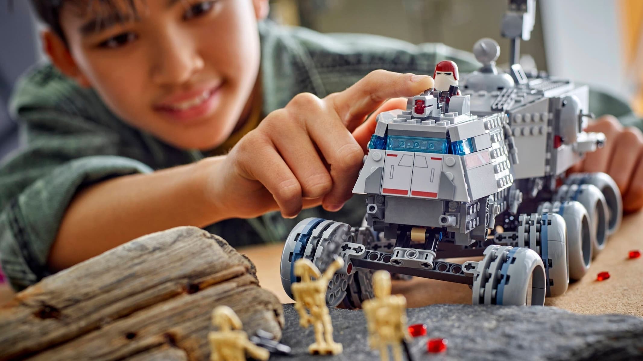 A young boy playing with the Lego Star Wars Republic Juggernaut