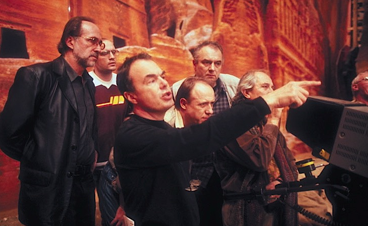 a man in black directing a film crew