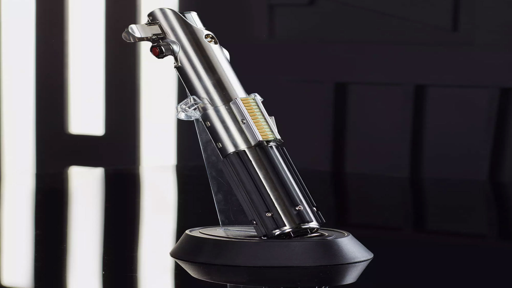 A silver metal hilt is on display as a blue lightsaber is on a black background.