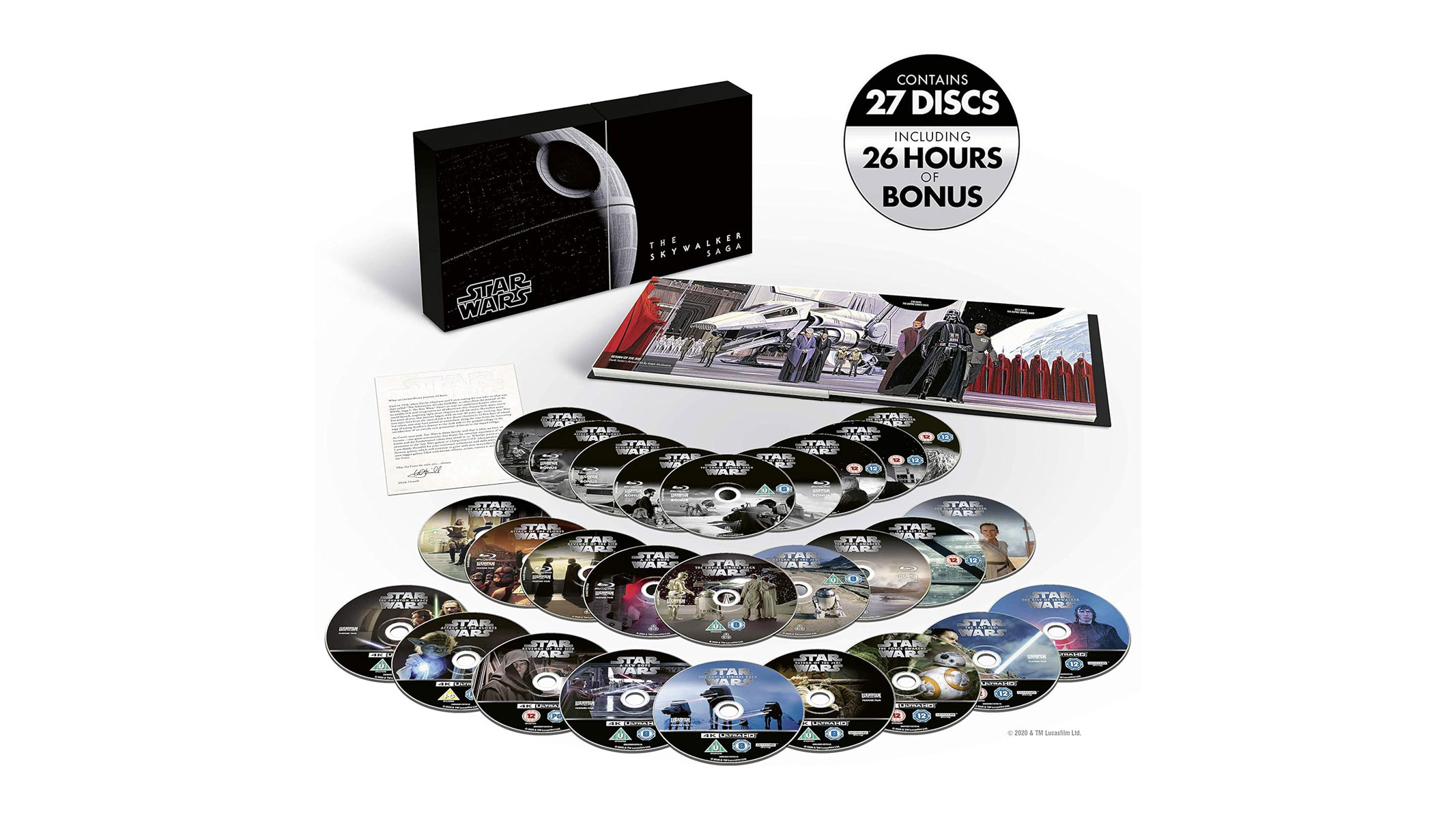 A collection of disks are laid out in front of a book and a box, all on a white background.