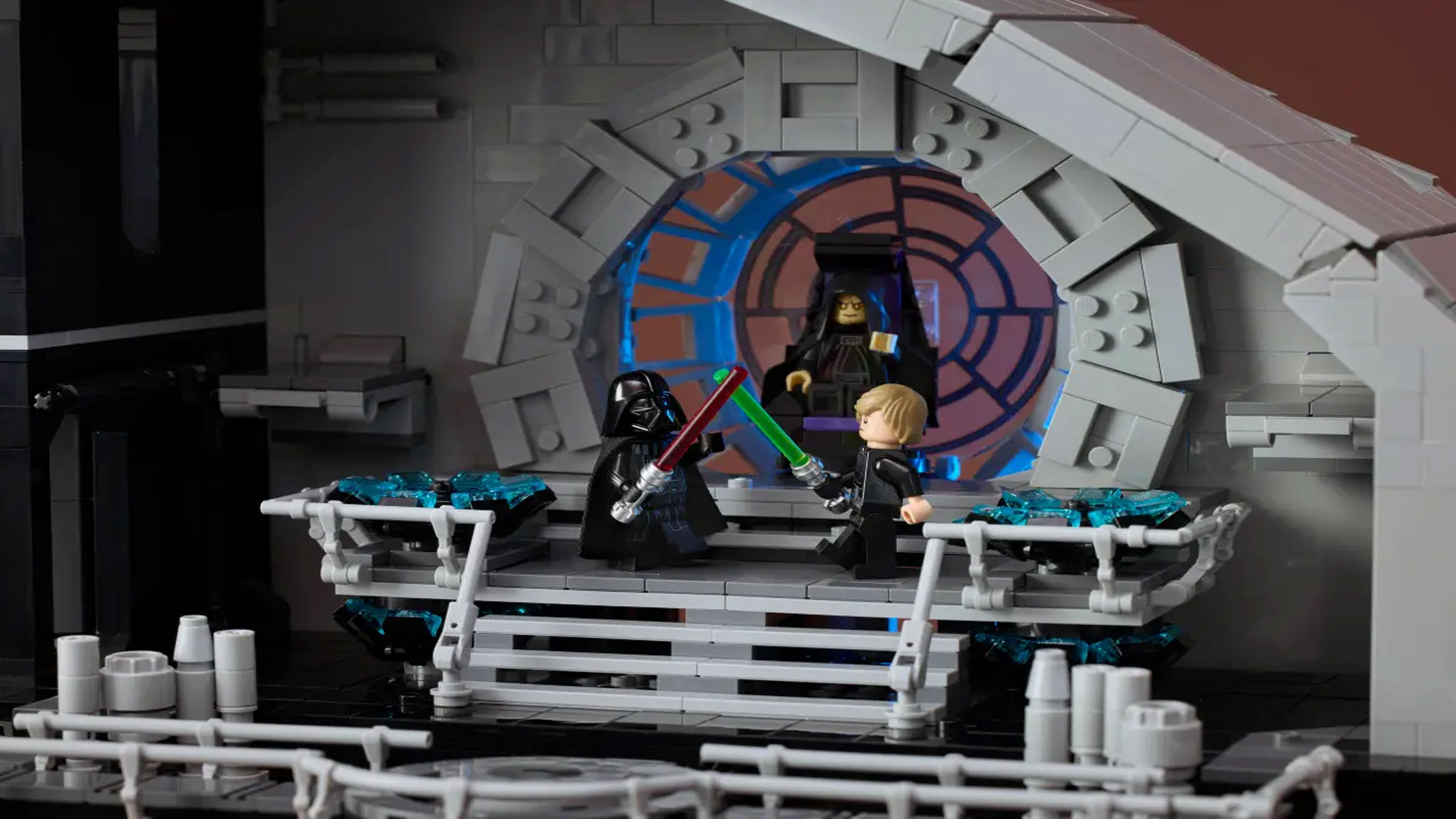 The interior of a circular space station with several floors and rooms filled with minifigures shows the minifigures posed in action.
