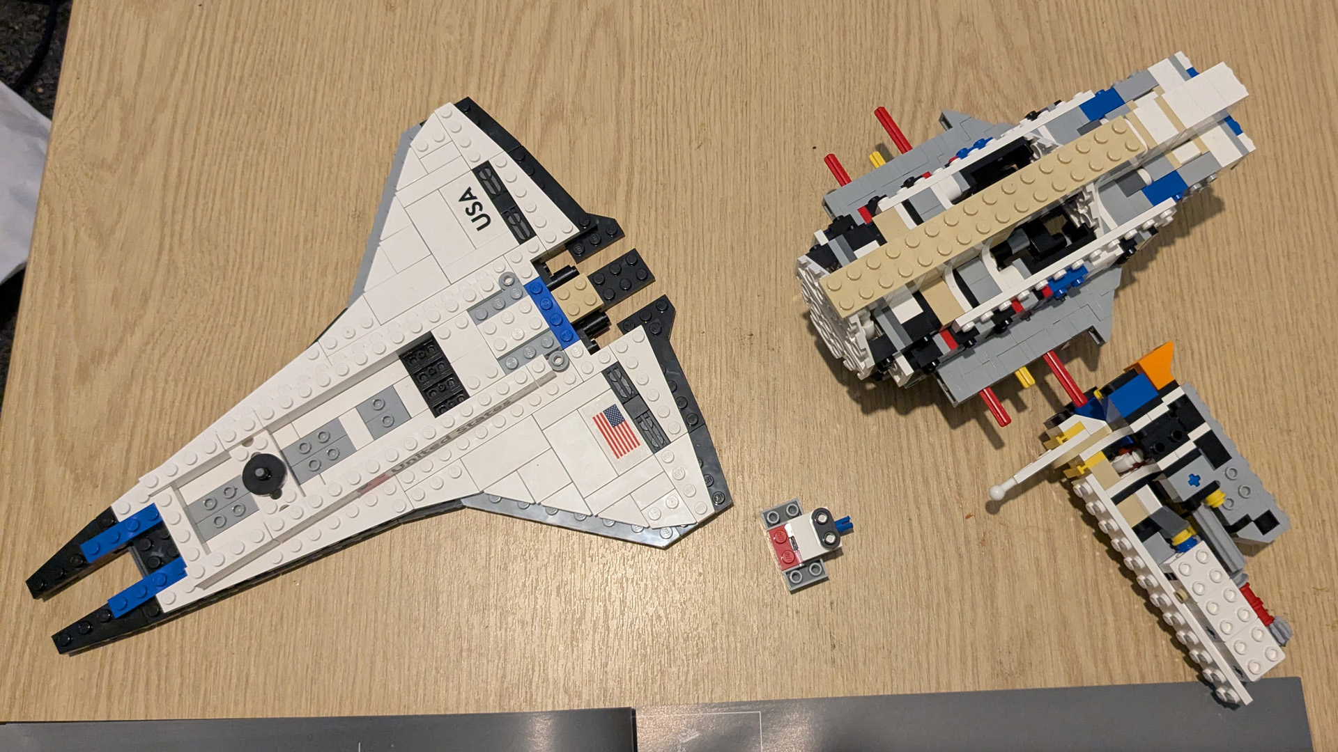 Lego Icons Shuttle Aircraft Carrier in pieces, a partly built shuttle and the partly built fuselage of the aircraft. 