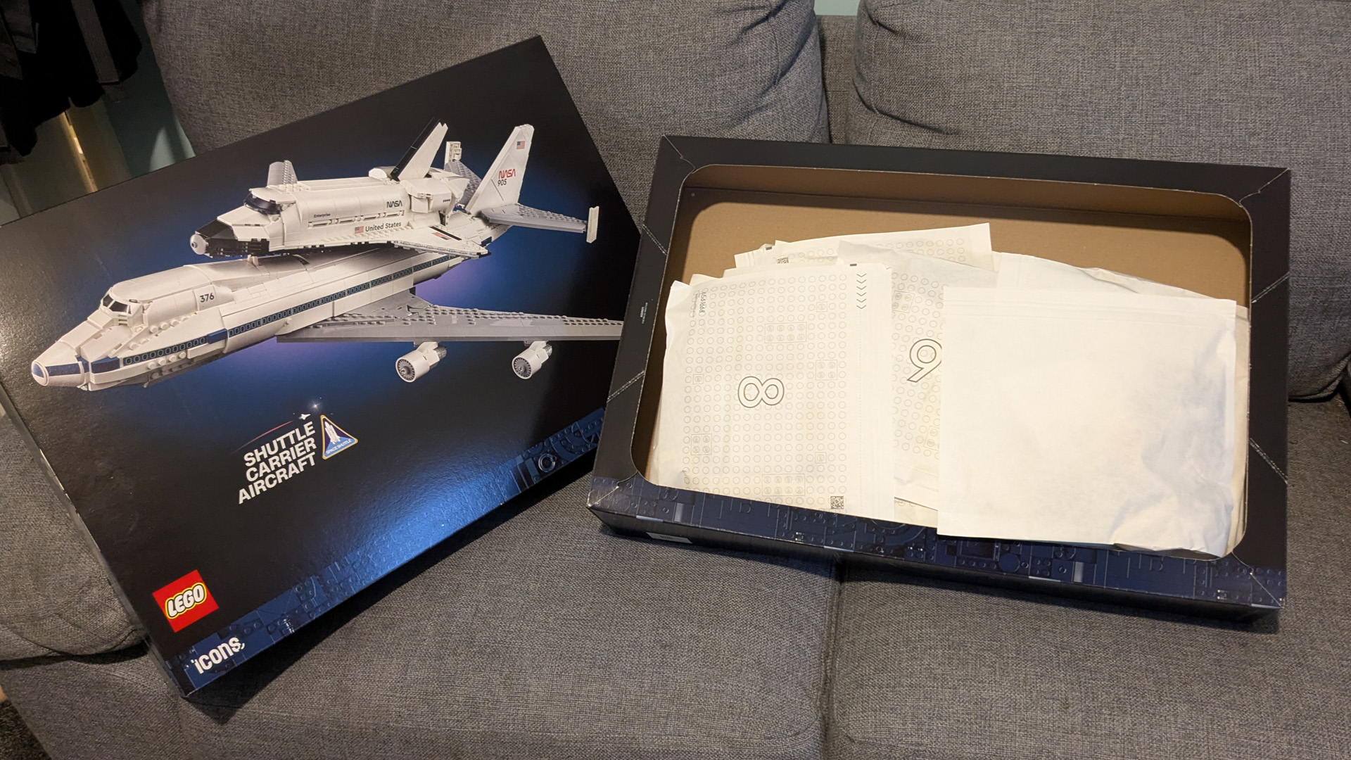 A Lego Icons Shuttle Aircraft Carrier box with the parts in bags. 