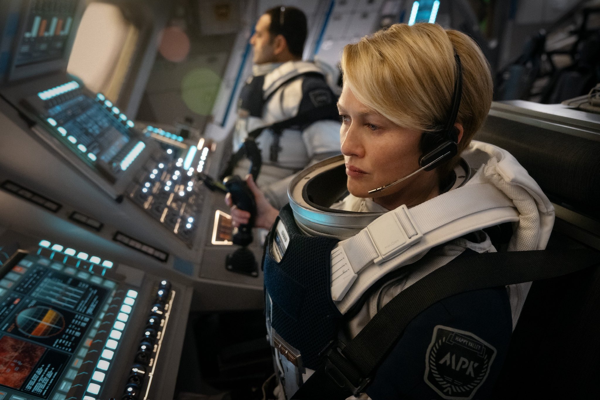 a blonde female astronaut aboard a spaceship