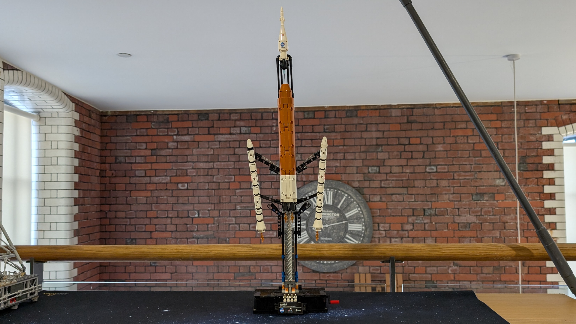 The Lego Technic NASA SLS set shown at maximum elevation with the rocket boosters detaching and the Orion module blasting out of the top.