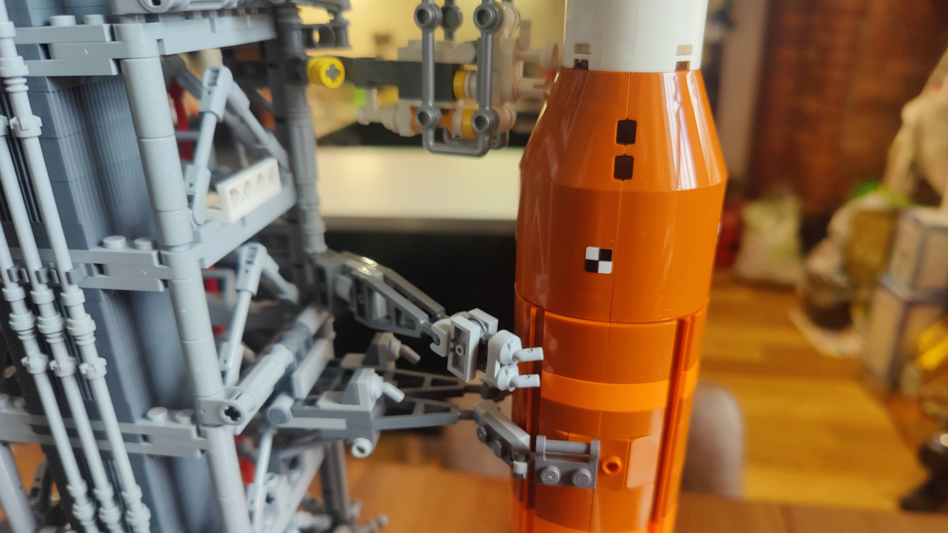 A close up of the Lego NASA Artemis Space Launch System, showing how the rocket connects to the launch tower.