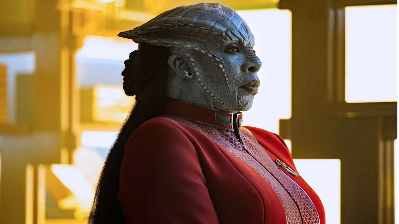 a blue-skinned female alien with a ridged skull