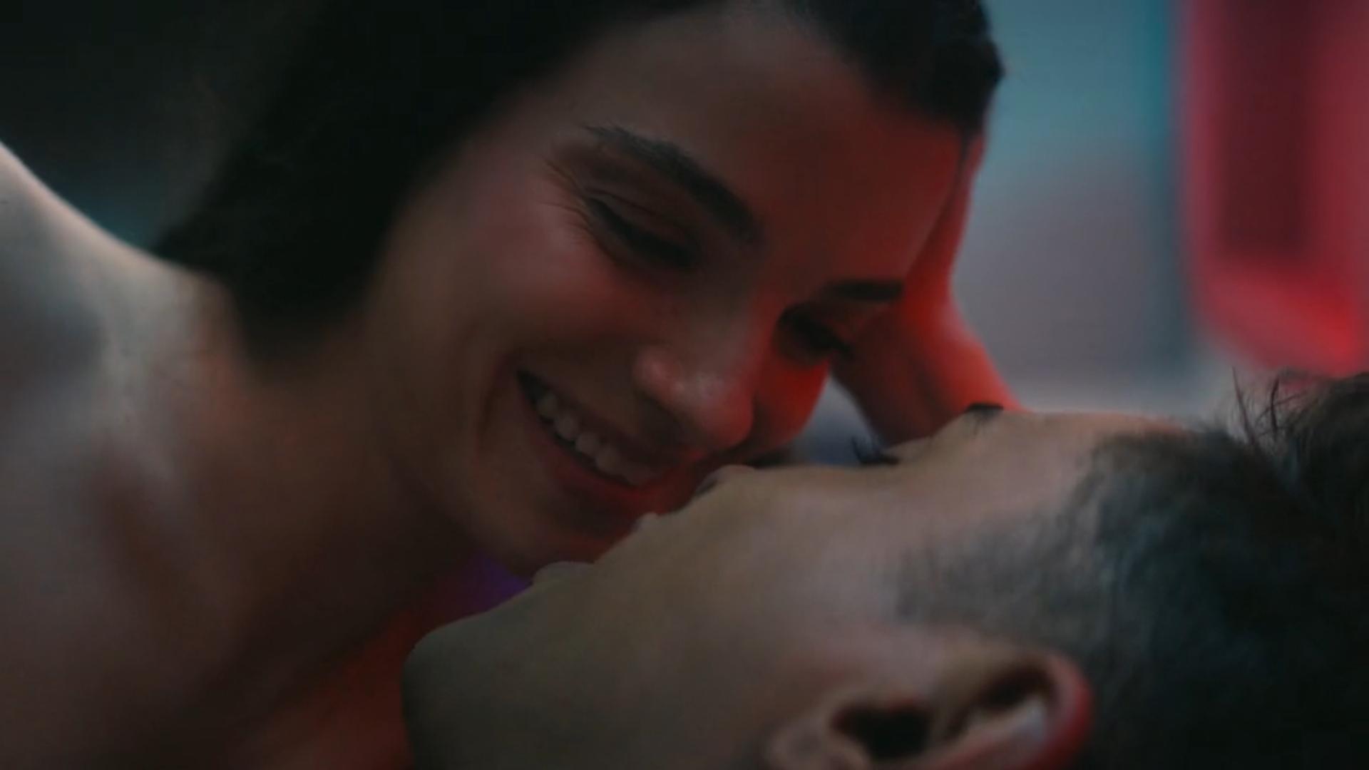 Screenshot from Star Trek: Starfleet Academy showing a man and a woman lying in bed together, looking into each other's eyes.