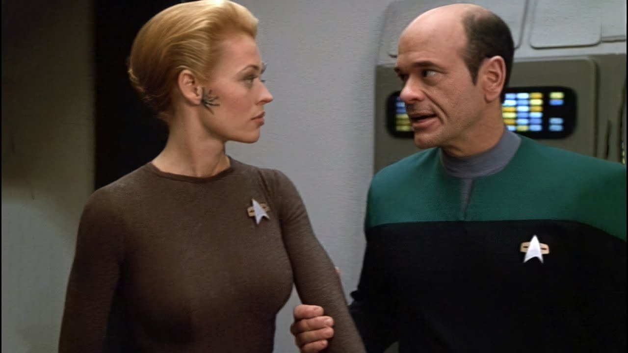 Seven of Nine and the Doctor, with the latter holding the former's arm, in Star Trek Voyager.
