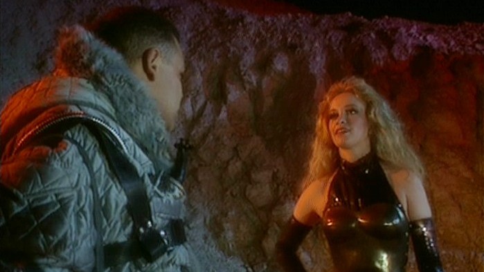 Still from the British sci-fi sitcom called Red Dwarf. Here we see Lister talking to the extremely attractive Camille, a pleasure GELF (genetically engineered lifeform).