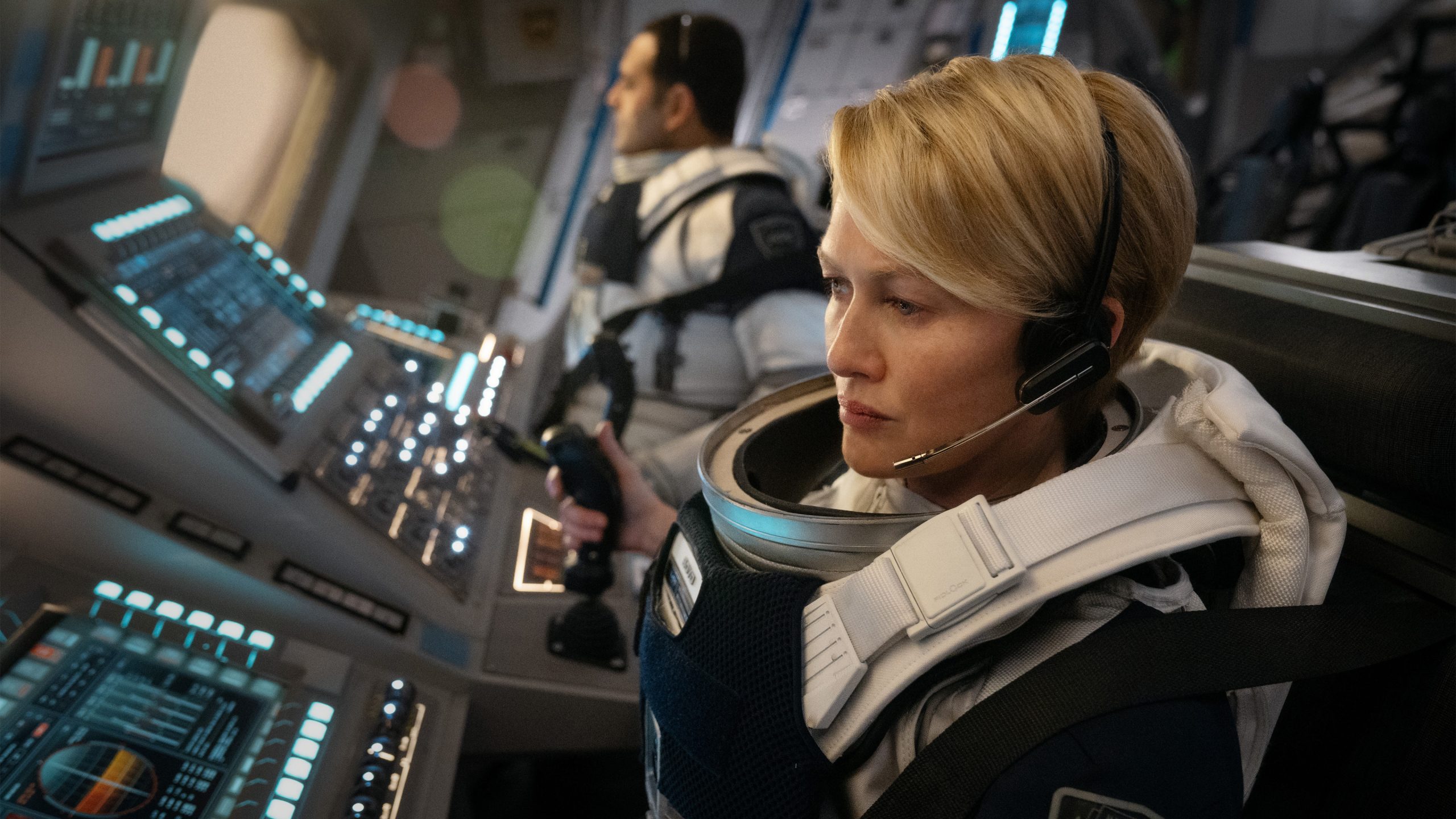 a woman pilot at the controls of a spacecraft