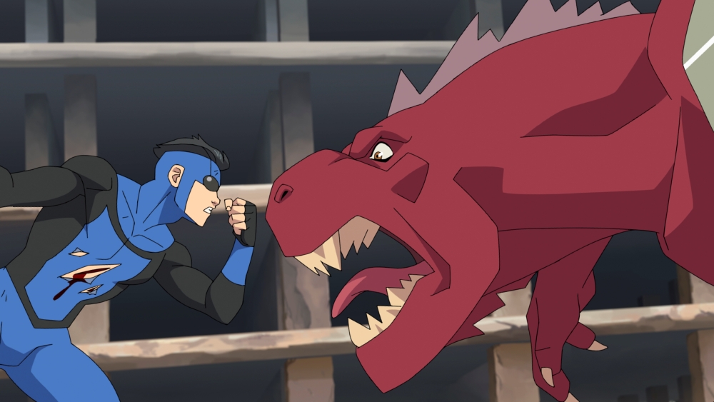 a costumed superhero fighting a red dinosaur