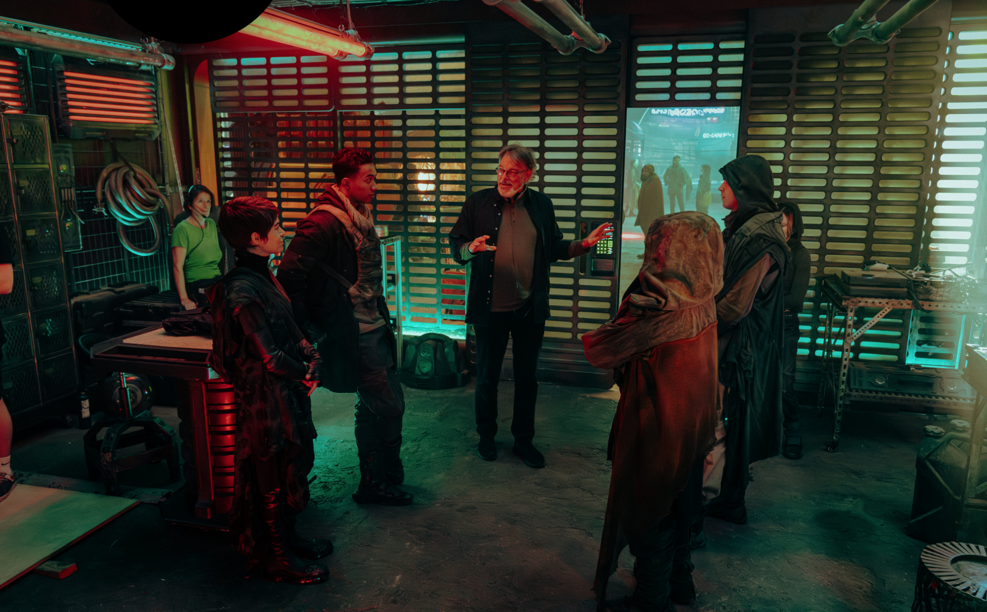 a director on a sci-fi set instructing his cast