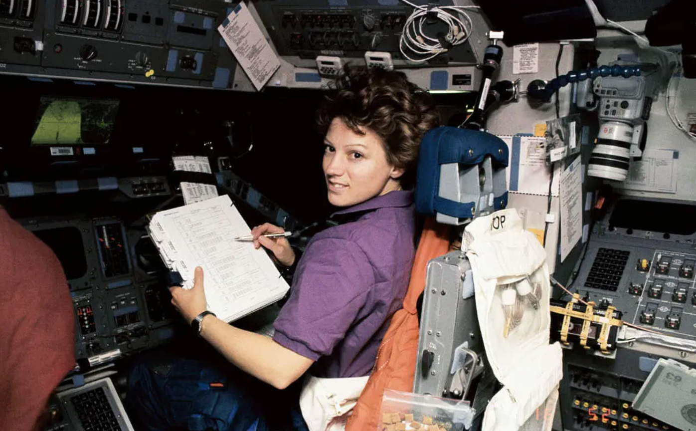 a female space shuttle pilot working in space
