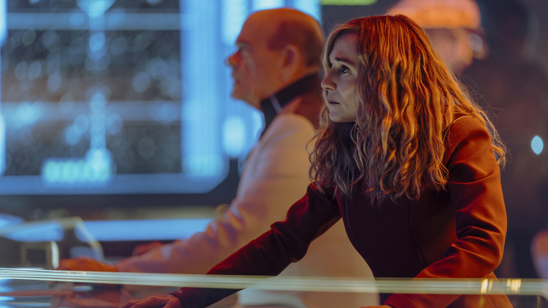 people in futuristic clothing in a brightly lit room