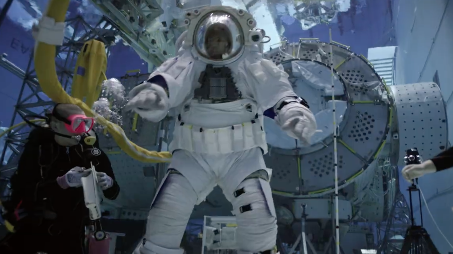 an astronaut training in a deep water pool