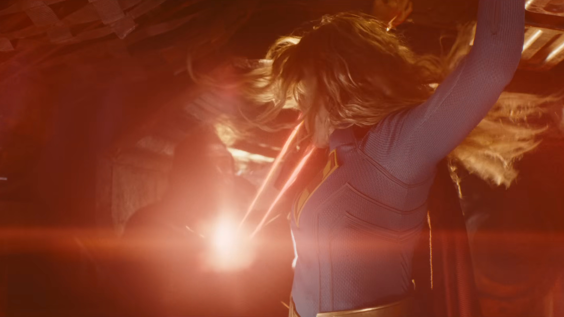 A female superhero using heat vision to blast a bad guy