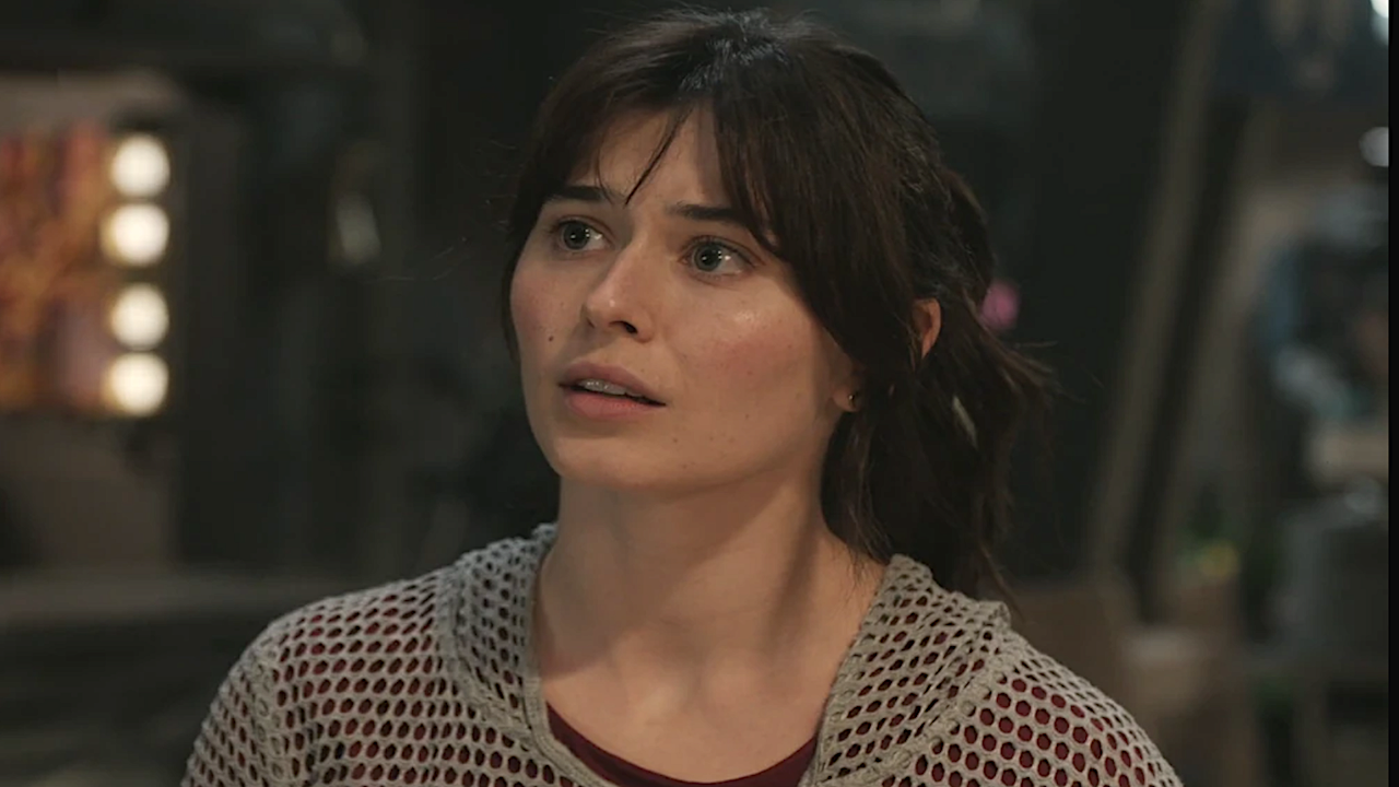 a dark-haired woman with a curious expression