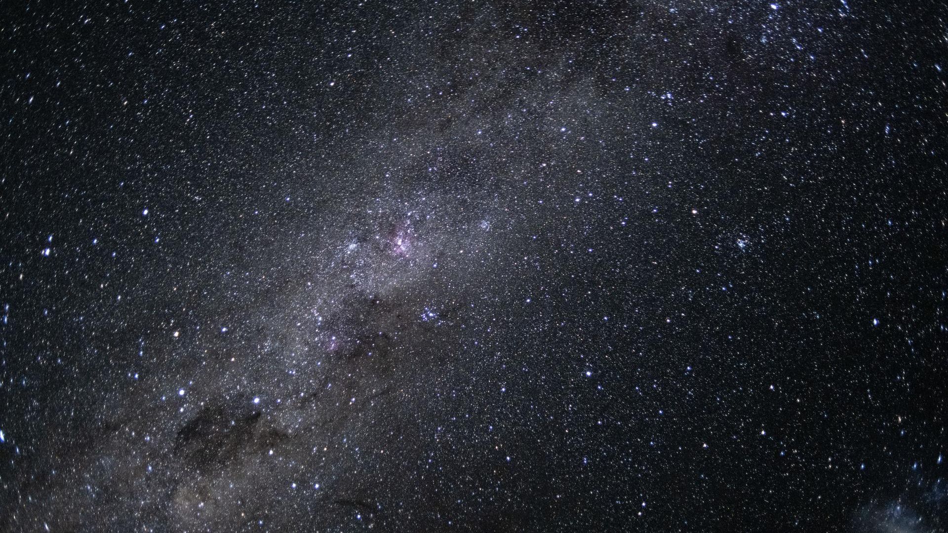 star studded sky with a bright center showing the milky way stretching across the scene.